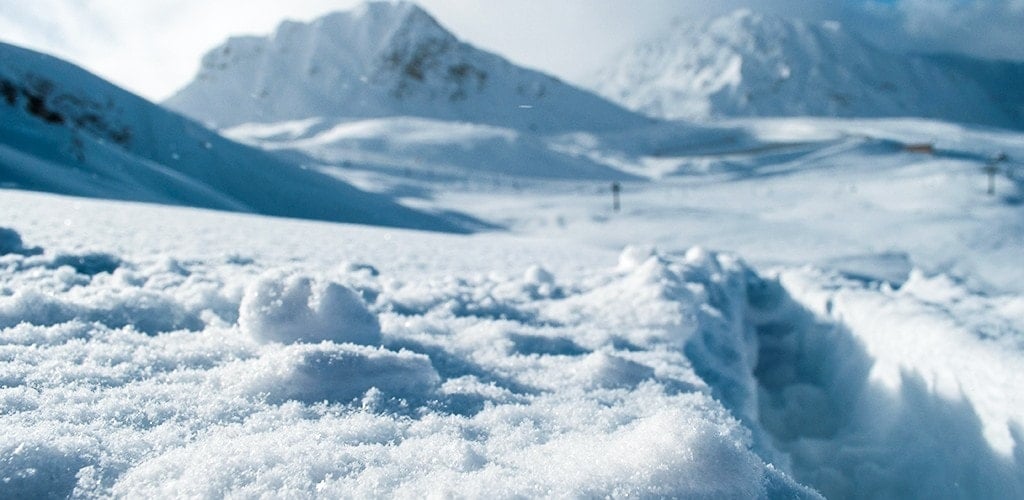 Chairlifts cross wide open powder fields