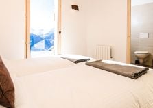 An ensuite chalet bedroom with mountain views