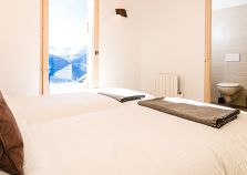 An ensuite chalet bedroom with mountain views