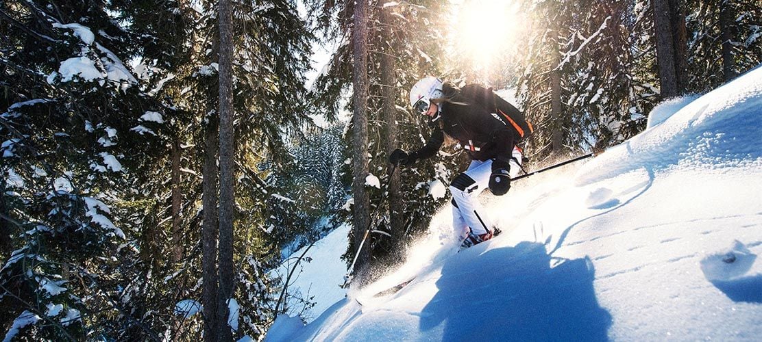 Off piste skiing in the trees by Courchevel Le Praz